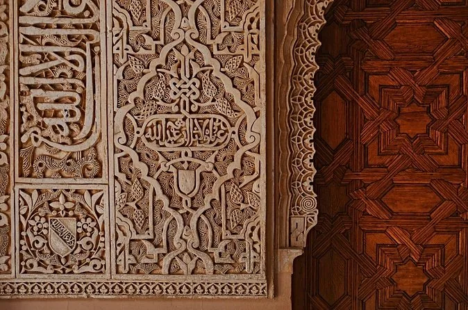 Detail of carved stucco and painted wooden doors in the Nasrid Palaces